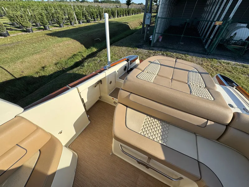 Slide: The Image of 2022 Chris-Craft Launch 25 GT interior with tan seating and outdoor setting. - 9