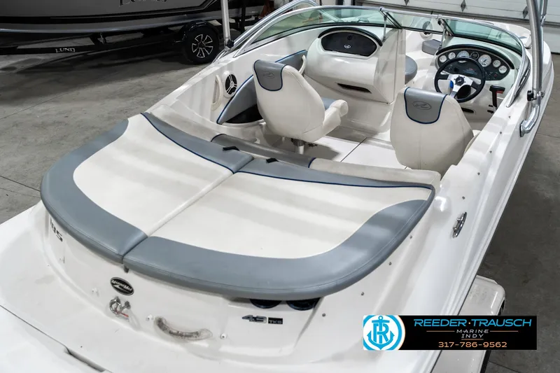 Slide: The Image of 2008 Sea Ray 185 Sport boat interior with white and gray seating, steering wheel, and dashboard. - 14