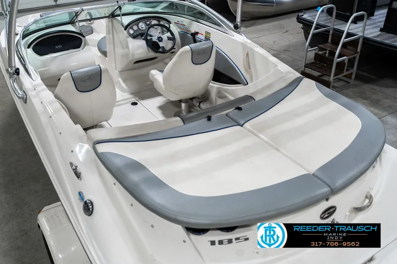 Slide: The Image of 2008 Sea Ray 185 Sport boat interior with white and gray seating, steering wheel, and dashboard. - 15