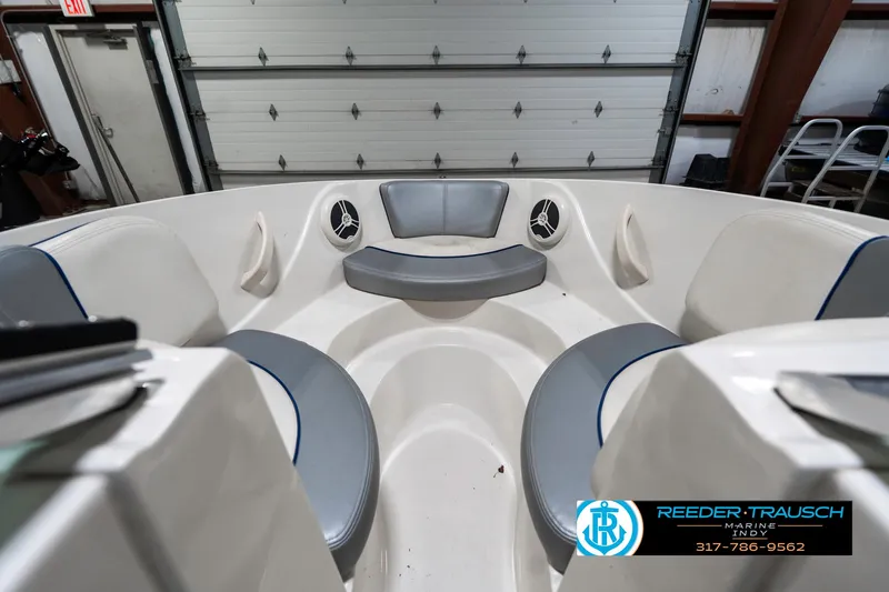 Slide: The Image of 2008 Sea Ray 185 Sport boat interior with gray seating in a garage. - 18