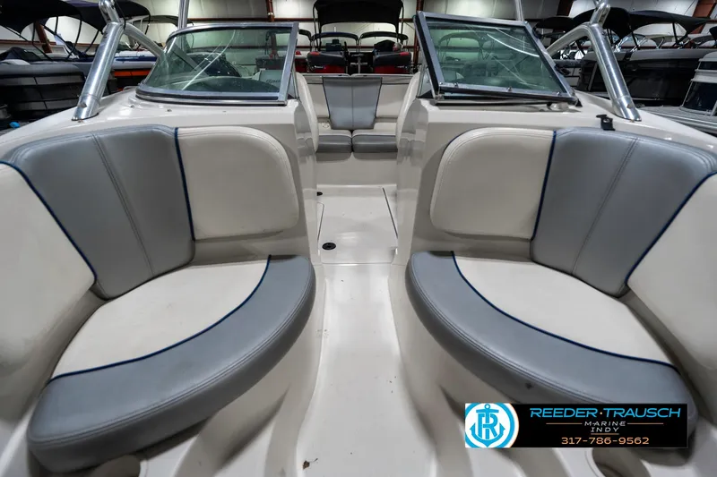 Slide: The Image of 2008 Sea Ray 185 Sport boat interior with gray seating and windshield. - 19