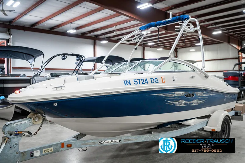 Slide: The Image of 2008 Sea Ray 185 Sport boat on trailer in indoor showroom. - 2
