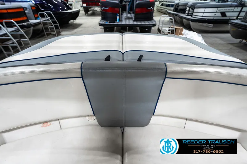 Slide: The Image of 2008 Sea Ray 185 Sport boat interior with white and gray seating in showroom. - 21