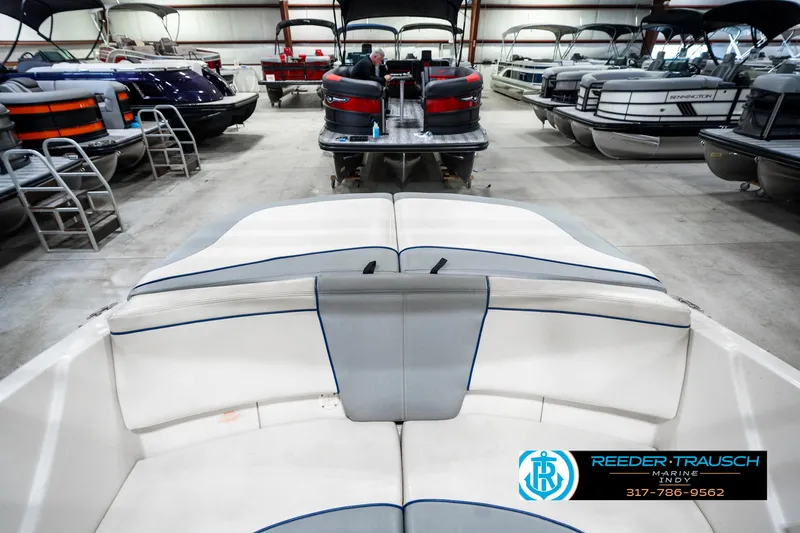 Slide: The Image of 2008 Sea Ray 185 Sport boat interior in a showroom with other boats. - 26