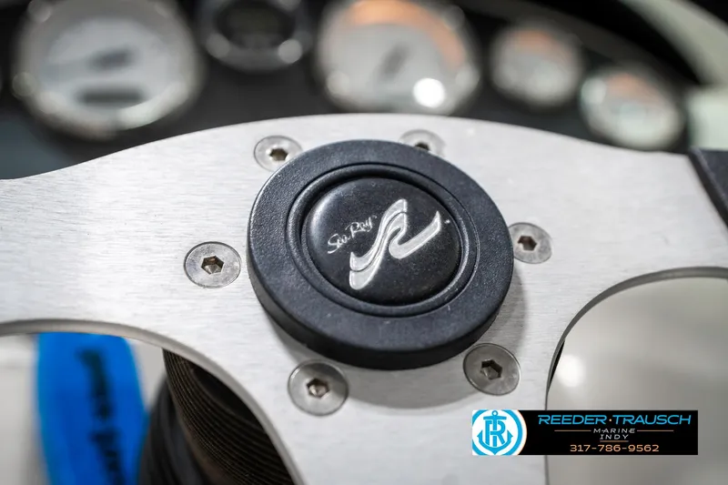 Slide: The Image of 2008 Sea Ray 185 Sport steering wheel with logo, dashboard gauges in background. - 30
