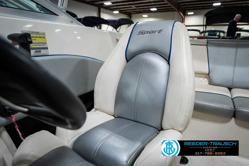 Slide: The Image of 2008 Sea Ray 185 Sport boat interior with gray and white seating in showroom. - 34
