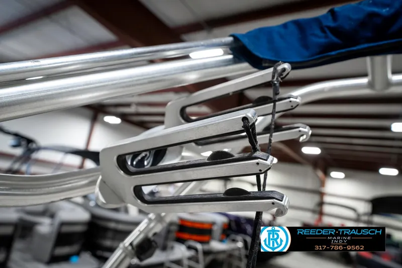 Slide: The Image of 2008 Sea Ray 185 Sport boat detail in indoor showroom, featuring sleek metal components. - 39