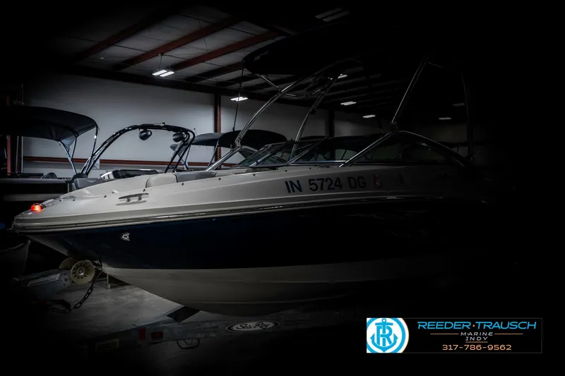 Slide: The Image of 2008 Sea Ray 185 Sport boat in a dimly lit showroom. - 4