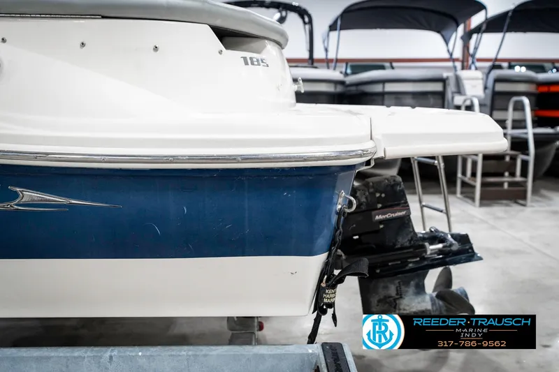 Slide: The Image of 2008 Sea Ray 185 Sport boat in showroom, featuring blue and white exterior. - 42