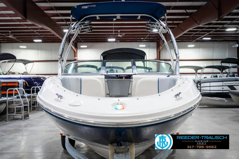 Slide: The Image of 2008 Sea Ray 185 Sport boat in showroom, front view with blue canopy. - 5