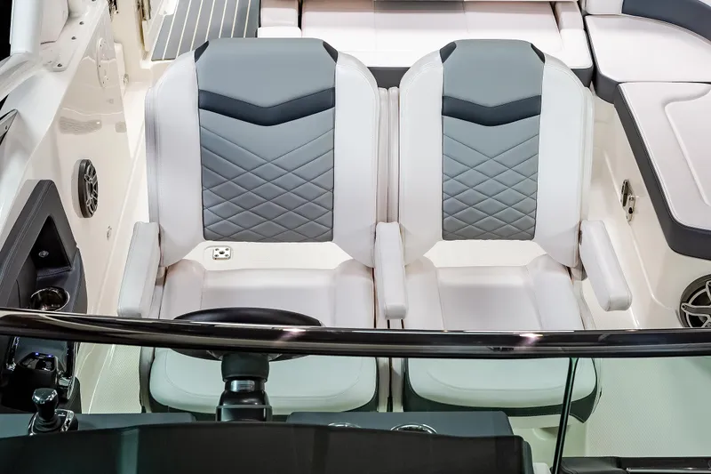 Slide: The Image of 2025 Chaparral 280 OSX boat interior with dual gray and white seats, modern design. - 38