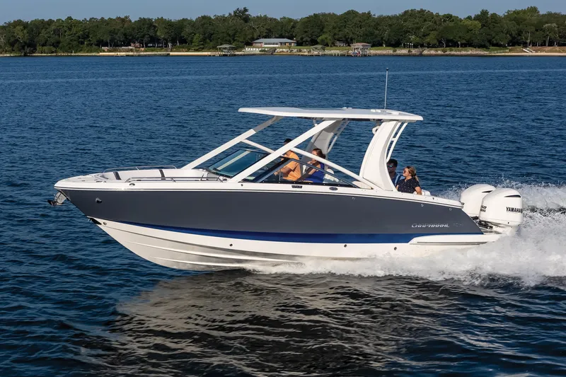 Slide: The Image of 2025 Chaparral 280 OSX boat cruising on a lake with passengers onboard. - 4