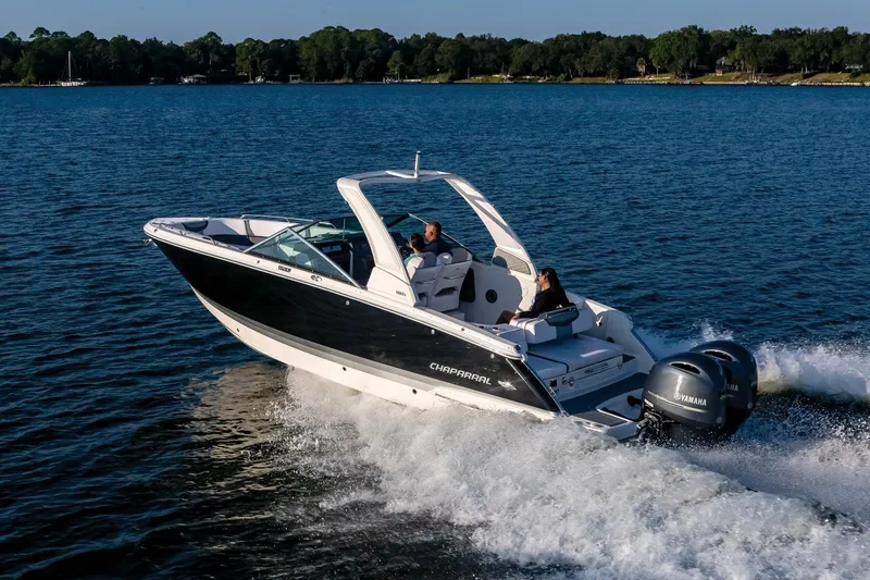 Slide: The Image of 2025 Chaparral 280 OSX boat cruising on a serene lake. - 6