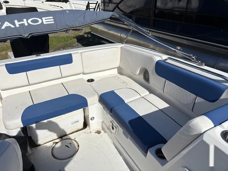 Slide: The Image of Interior of a 2020 Tahoe 1950 boat with blue and white seating. - 4
