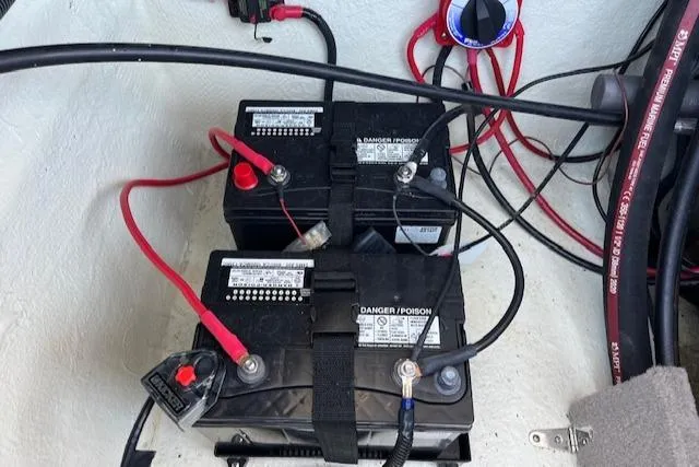 Slide: The Image of Dual batteries in a 2021 Stingray 225 SE boat, connected with red and black cables. - 7