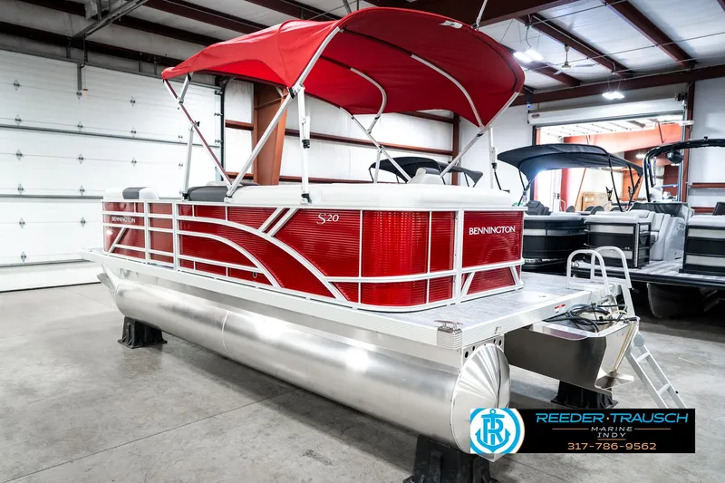 Slide: The Image of 2025 Bennington 20 SL pontoon boat with red canopy in showroom. - 10