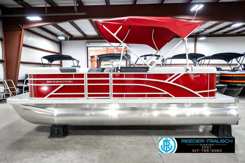 Slide: The Image of 2025 Bennington 20 SL pontoon boat with red canopy in showroom. - 11