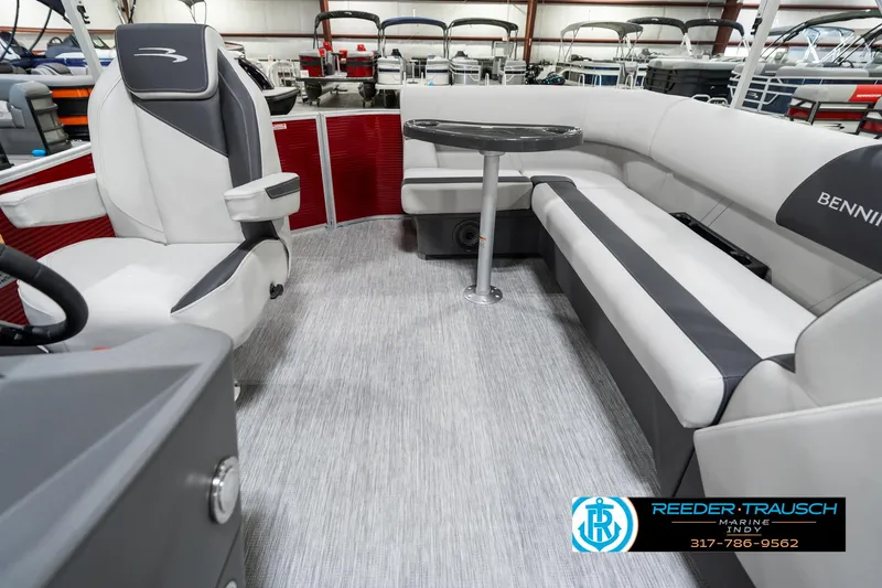 Slide: The Image of 2025 Bennington 20 SL pontoon boat interior with gray seating and table, showcasing modern design. - 17