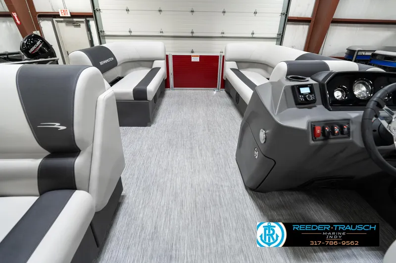 Slide: The Image of 2025 Bennington 20 SL pontoon boat interior with gray seating and modern dashboard. - 20