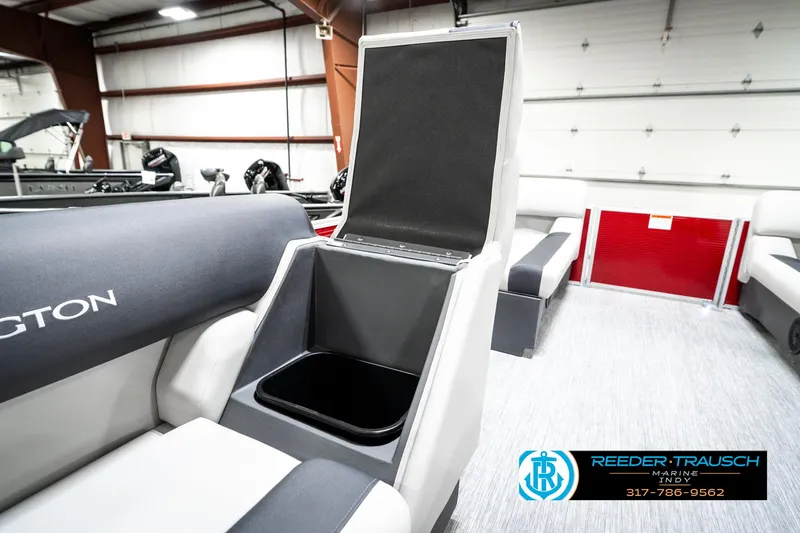 Slide: The Image of 2025 Bennington 20 SL boat interior with open storage compartment in showroom. - 24