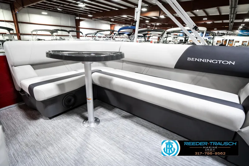 Slide: The Image of 2025 Bennington 20 SL pontoon boat interior with sleek seating and table. - 25