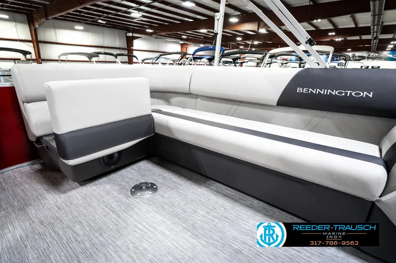 Slide: The Image of 2025 Bennington 20 SL pontoon boat interior with sleek seating in showroom. - 28