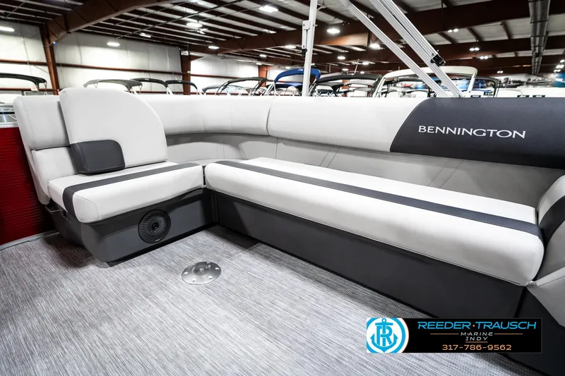 Slide: The Image of 2025 Bennington 20 SL pontoon boat interior with gray seating in showroom. - 29