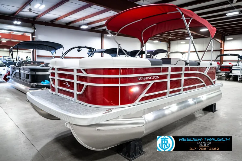 Slide: The Image of 2025 Bennington 20 SL pontoon boat with red canopy in showroom. - 3