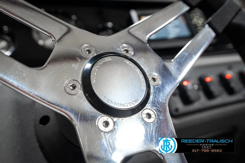 Slide: The Image of Steering wheel of 2025 Bennington 20 SL boat, featuring sleek metallic design. - 32