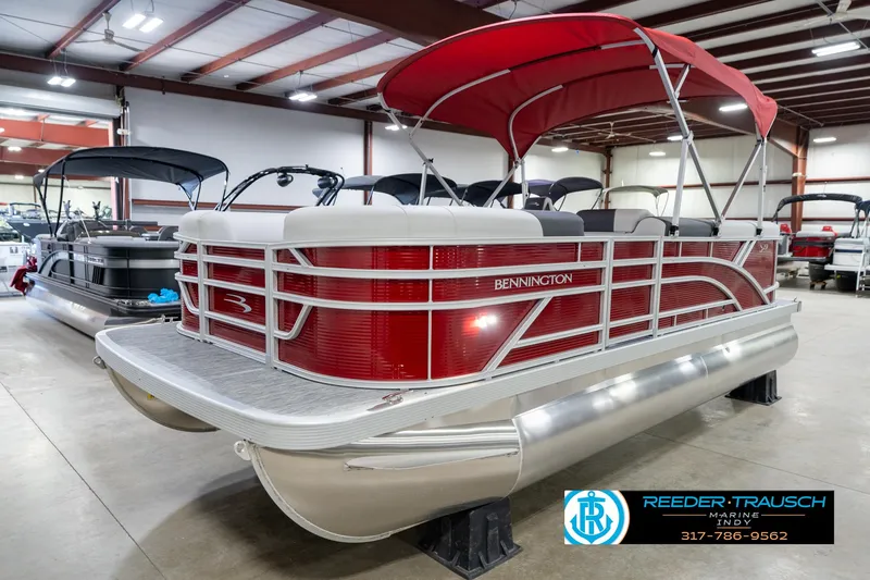 Slide: The Image of 2025 Bennington 20 SL pontoon boat with red canopy in showroom. - 4