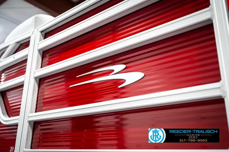 Slide: The Image of 2025 Bennington 20 SL boat with red and white detailing, Reeder-Trausch Marine logo visible. - 45