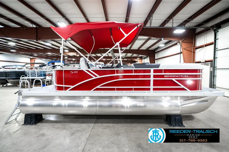 Slide: The Image of 2025 Bennington 20 SL pontoon boat with red canopy in a showroom. - 7