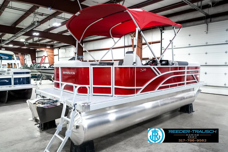 Slide: The Image of 2025 Bennington 20 SL pontoon boat with red canopy in showroom. - 8
