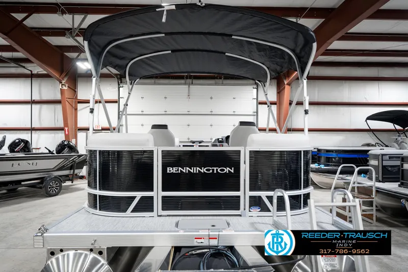 Slide: The Image of 2025 Bennington 20 SSR pontoon boat in showroom with canopy and sleek design. - 10