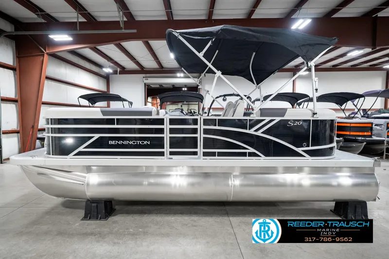 Slide: The Image of 2025 Bennington 20 SSR pontoon boat in showroom with canopy and sleek design. - 12