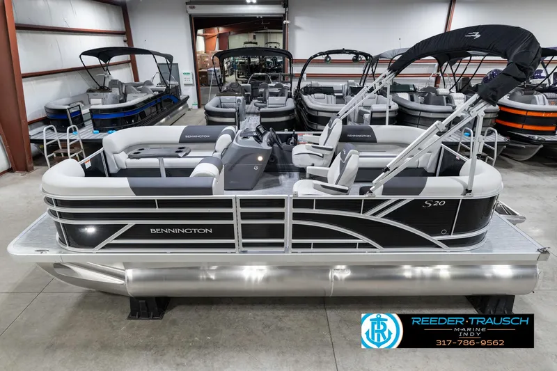Slide: The Image of 2025 Bennington 20 SSR pontoon boat in showroom, featuring sleek design and modern seating. - 2