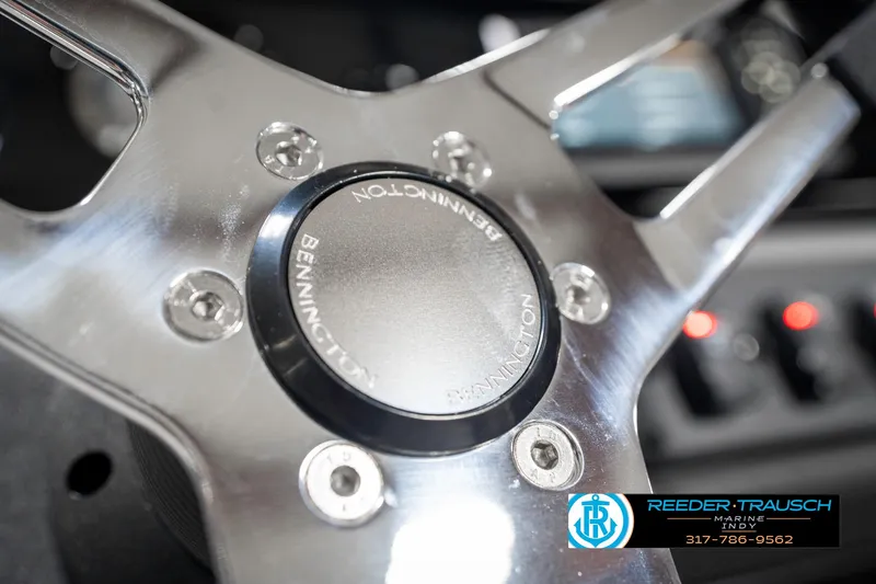 Slide: The Image of Steering wheel of 2025 Bennington 20 SSR boat, featuring sleek metallic design. - 31