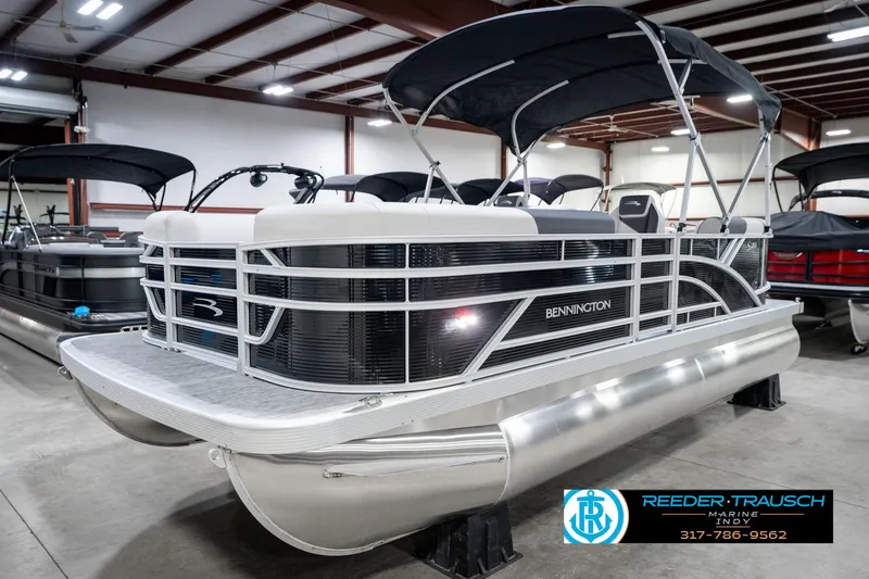 Slide: The Image of 2025 Bennington 20 SSR pontoon boat in showroom with canopy and sleek design. - 4