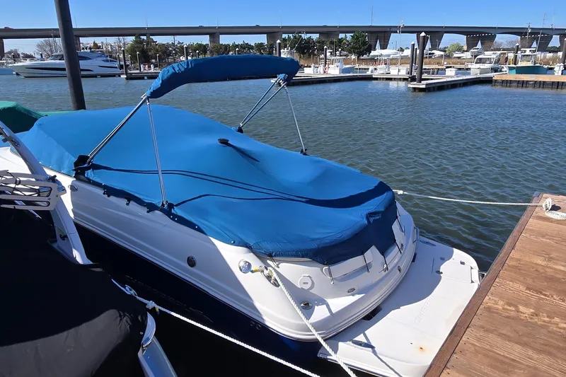 Slide: The Image of 2007 Chaparral 246 SSi boat docked with blue cover in marina. - 2
