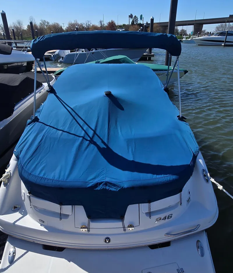 Slide: The Image of 2007 Chaparral 246 SSi boat with blue cover docked at marina. - 3