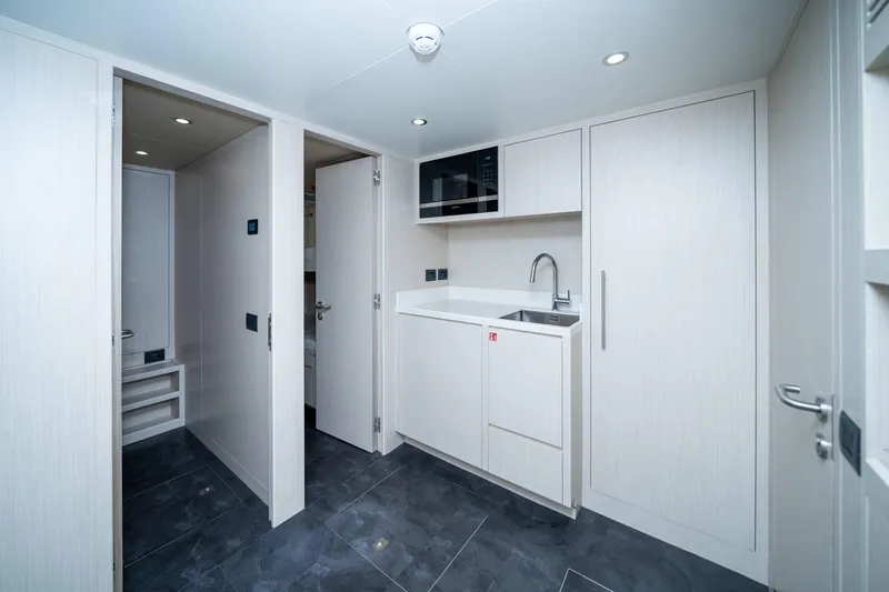 Slide: The Image of Modern interior of 2024 Nomad 75 SUV with sleek cabinetry and compact kitchenette. - 22