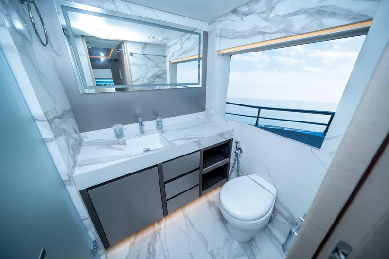 Slide: The Image of Luxurious bathroom in 2024 Nomad 75 SUV yacht with marble decor and ocean view. - 23