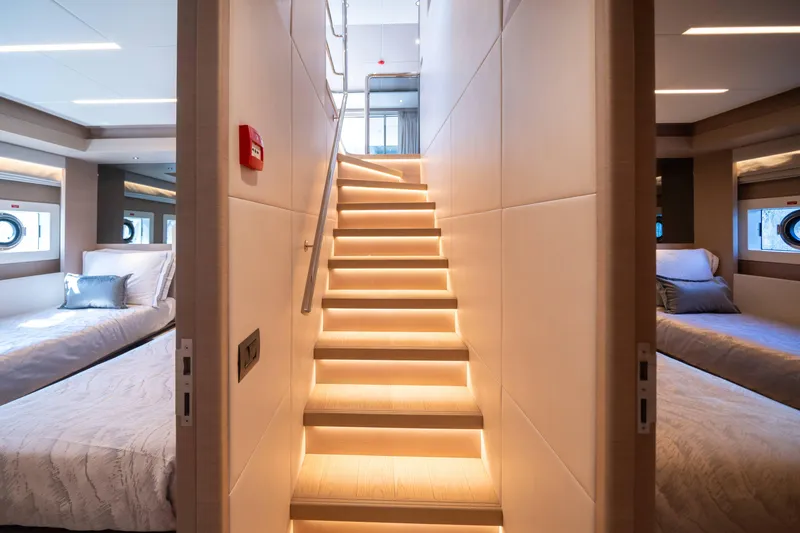Slide: The Image of Luxurious interior of 2024 Nomad 75 SUV yacht with illuminated staircase and cozy bedrooms. - 26