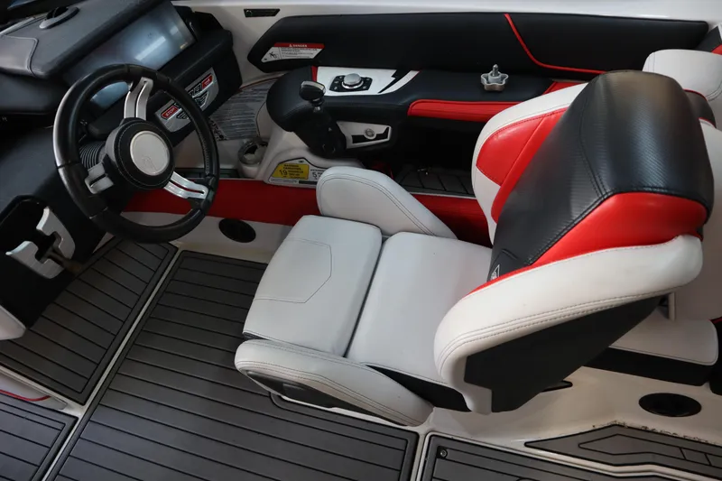 Slide: The Image of 2018 Nautique Super Air Nautique G25 interior with sleek steering and modern seating. - 12