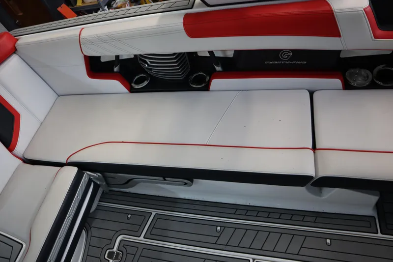 Slide: The Image of 2018 Nautique Super Air Nautique G25 interior with red and white seating and cup holders. - 16