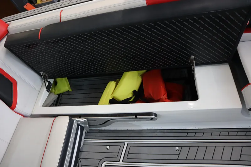 Slide: The Image of 2018 Nautique Super Air Nautique G25 boat storage compartment with life jackets. - 17