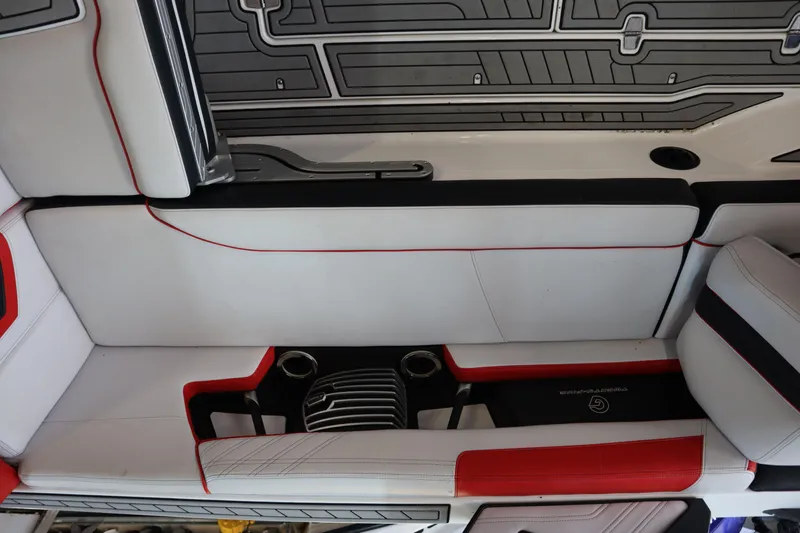 Slide: The Image of 2018 Nautique Super Air Nautique G25 interior with red and white seating and cup holders. - 18