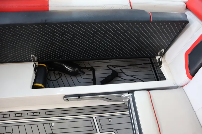 Slide: The Image of 2018 Nautique Super Air Nautique G25 storage compartment with open seat and accessories. - 19