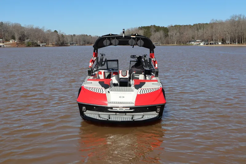 Slide: The Image of 2018 Nautique Super Air Nautique G25 boat on a calm lake. - 2