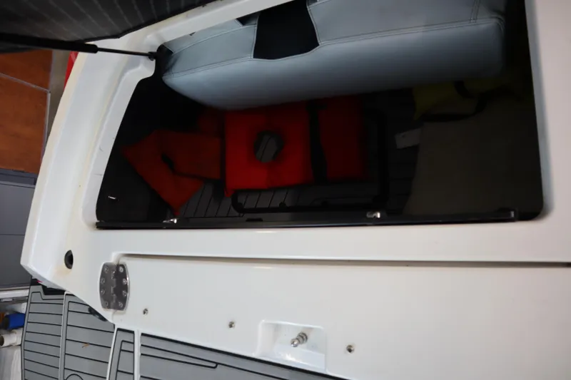 Slide: The Image of 2018 Nautique Super Air Nautique G25 storage compartment with life jackets. - 21